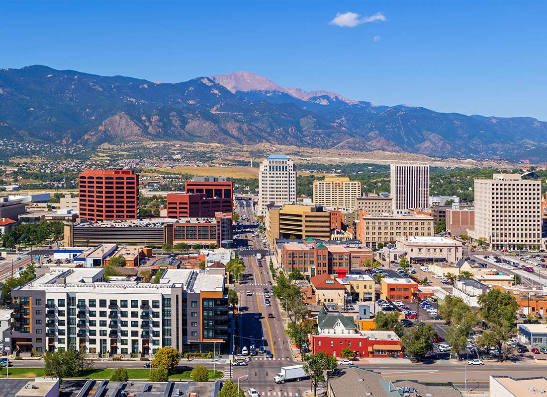 Colorado Springs, CO - View of Commercial Buildings in Downtown Colorado Springs Colorado on a Sunny Day with Views of the Mountains in the Background