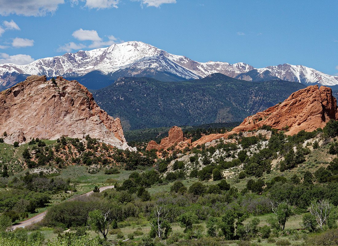 Contact - Scenic View of a State Park with Green Trees Surrounded by Mountains and Rock Formations in Colorado Springs Colorado on a Sunny Day